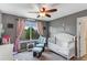 Charming Bedroom with a crib, rocking chair, soft décor, and natural light at 10614 Kicking Horse Dr, Littleton, CO 80125