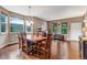 Spacious dining room boasts hardwood floors, large windows, and an inviting atmosphere at 10614 Kicking Horse Dr, Littleton, CO 80125