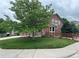 Two-story home with mature trees, manicured lawn, and a cozy front porch at 10614 Kicking Horse Dr, Littleton, CO 80125