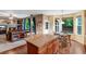 Open kitchen with a granite island, wooden cabinets, and a cozy breakfast nook with views of the living room at 10614 Kicking Horse Dr, Littleton, CO 80125