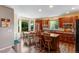 Bright kitchen with granite counters, an island with seating, a breakfast nook, and ample cabinet space at 10614 Kicking Horse Dr, Littleton, CO 80125