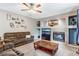 Comfortable living room featuring a fireplace, large sofa, and neutral carpeting at 10614 Kicking Horse Dr, Littleton, CO 80125