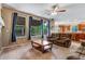 Inviting living room with blue curtains, backyard views, and adjoins kitchen at 10614 Kicking Horse Dr, Littleton, CO 80125