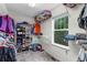 Spacious walk-in closet with ample storage and natural light from a large window at 10614 Kicking Horse Dr, Littleton, CO 80125