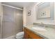 Bathroom with shower with glass door and vanity with white sink and granite countertops at 130 N Pearl St # 304, Denver, CO 80203