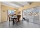 Sunny dining room with hardwood floors, beamed ceilings, modern light fixture, and sliding glass doors to outside patio at 130 N Pearl St # 304, Denver, CO 80203