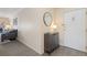 Welcoming condo entryway featuring modern gray floors, cabinet with decor and a mirror, creating an inviting atmosphere at 130 N Pearl St # 304, Denver, CO 80203
