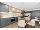Updated kitchen featuring custom cabinets, stainless steel appliances, marble backsplash, and an adjacent dining area at 130 N Pearl St # 304, Denver, CO 80203
