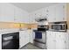 Modern kitchen featuring stainless steel appliances, white cabinets, and sleek countertops and modern flooring at 130 N Pearl St # 304, Denver, CO 80203
