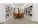 Library with built-in bookshelves, hardwood flooring, and large comfortable seating at 130 N Pearl St # 304, Denver, CO 80203