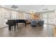 Bright living room with large windows, herringbone floors, piano, and a comfortable sitting area with gray sofas at 130 N Pearl St # 304, Denver, CO 80203