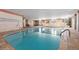 Indoor pool with ample natural light, tile surround, and tables with chairs for relaxation at 130 N Pearl St # 304, Denver, CO 80203