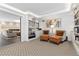 Cozy sitting area featuring custom built-ins, two chairs with ottomans, and open access to a living room with a fireplace at 130 N Pearl St # 304, Denver, CO 80203