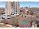 Outdoor tennis courts with city views, parking lot, landscaping and building at 130 N Pearl St # 304, Denver, CO 80203