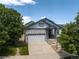 Charming home exterior features a stone facade, manicured lawn, and a two-car garage, creating a welcoming curb appeal at 23421 E Long Pl, Aurora, CO 80016