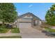 Inviting front exterior shows well kept lawn, mature trees and the home's architectural details at 23421 E Long Pl, Aurora, CO 80016