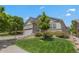 Landscaped front yard leads to a charming house with stone accents and a welcoming entrance at 23421 E Long Pl, Aurora, CO 80016