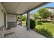Inviting covered front porch with columns, landscaped yard, and views of the neighborhood at 23421 E Long Pl, Aurora, CO 80016