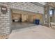 Spacious two-car garage with stone walls offers ample parking and storage, enhancing the home's functionality at 23421 E Long Pl, Aurora, CO 80016