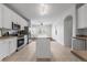 Bright kitchen featuring white cabinets, stainless steel appliances, tile floors, and an island at 23421 E Long Pl, Aurora, CO 80016
