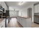 Bright, open kitchen featuring an island and modern stainless steel appliances at 23421 E Long Pl, Aurora, CO 80016