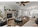 Cozy living room with a modern fireplace, built-in shelves, and a comfortable seating area at 23421 E Long Pl, Aurora, CO 80016