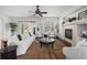 Bright living room featuring a modern fireplace, large window, stylish decor and ceiling fan at 23421 E Long Pl, Aurora, CO 80016
