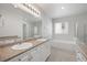 Main bathroom with double sinks, soaking tub, and separate shower at 23421 E Long Pl, Aurora, CO 80016