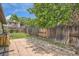 Private backyard with a patio, wooden fence, and a mature tree offering a peaceful outdoor space for relaxation at 5600 Dover St, Arvada, CO 80002