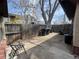 Fenced backyard features concrete patio, mature tree, and partial view of the home's exterior at 5600 Dover St, Arvada, CO 80002