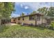 Cozy brick home backyard with a patio, lawn, and partially fenced area for outdoor enjoyment at 5600 Dover St, Arvada, CO 80002