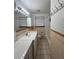 Bright bathroom with vanity, mirror, decorative tile, tub, and shower with curtain at 5600 Dover St, Arvada, CO 80002