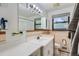 Classic bathroom with a white vanity, a large mirror, and tiled walls providing a clean and functional space at 5600 Dover St, Arvada, CO 80002