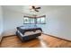 Simple bedroom with hardwood floors and a large window, offering a serene and comfortable space at 5600 Dover St, Arvada, CO 80002