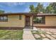 Charming home with a brick facade and inviting front door, featuring a well-manicured walkway and decorative details at 5600 Dover St, Arvada, CO 80002