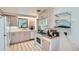 Functional kitchen featuring white appliances, classic cabinetry, and tile flooring for a clean and timeless appeal at 5600 Dover St, Arvada, CO 80002