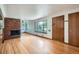 Bright living room with hardwood floors, a brick fireplace, and large windows offering plenty of natural light at 5600 Dover St, Arvada, CO 80002