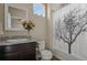 Well-lit bathroom with decorative mirror, granite counter, shower with curtain and tiled flooring at 1078 Oak Cir, Denver, CO 80215