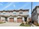 Townhome with a attached garage and neutral siding at 1078 Oak Cir, Denver, CO 80215