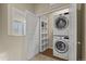 Convenient laundry area with washer, dryer, and shelving unit for organization and easy access at 1078 Oak Cir, Denver, CO 80215