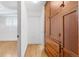 Hallway featuring hardwood floors, a built in cabinet, white walls, and leads into another room at 2533 E 11Th Ave # 1, Denver, CO 80206