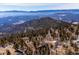 Aerial view of homes nestled among rolling hills and tall, lush evergreen trees at 11564 Green Ct, Conifer, CO 80433