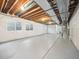 Unfinished basement featuring exposed wood ceiling, painted walls, and concrete floors at 5723 S Union Ct, Littleton, CO 80127