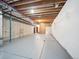 Spacious unfinished basement with high ceilings, exposed beams, and concrete flooring at 5723 S Union Ct, Littleton, CO 80127