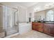 Elegant bathroom with a soaking tub, double vanity, and shower at 5723 S Union Ct, Littleton, CO 80127