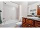 Full bathroom features tub/shower combo and wood vanity with granite counters at 5723 S Union Ct, Littleton, CO 80127