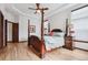 Main bedroom with a large four-poster bed and hardwood floors at 5723 S Union Ct, Littleton, CO 80127