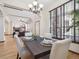 Elegant dining room with a modern chandelier, large window with blinds, and stylish decor at 5723 S Union Ct, Littleton, CO 80127