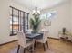 Cozy dining room featuring a modern chandelier, hardwood floors, and ample natural light from the windows at 5723 S Union Ct, Littleton, CO 80127