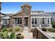 Charming home with a stone facade, covered porch, and manicured landscaping, providing excellent curb appeal at 5723 S Union Ct, Littleton, CO 80127